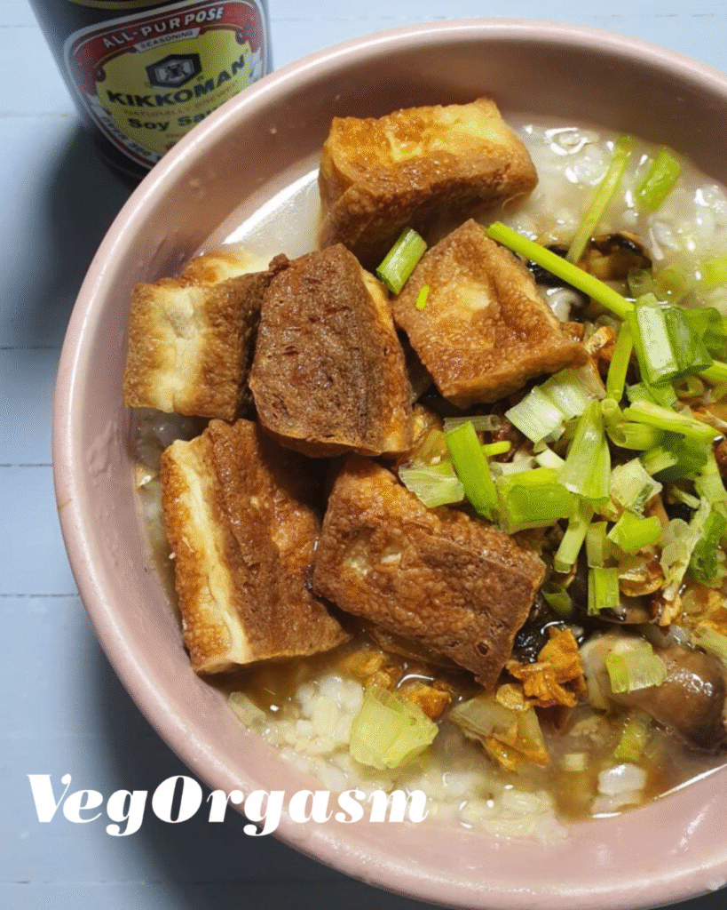 a bowl of lugaw with fried tofu and spring onions